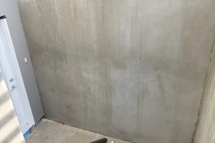 Clean concrete wall after professional pressure washing – Surrey